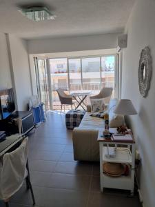 a living room with a couch and a table at Guzmán in Punta del Este