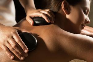 a woman getting a massage from a therapist at Mullion Cove Hotel & Spa in Mullion
