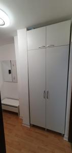 an empty room with a white cabinet in a room at Casa Rusu - Govandari -Self check in-24h in Reşiţa