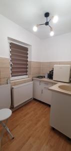 a kitchen with a window and a table and chairs at Casa Rusu - Govandari -Self check in-24h in Reşiţa