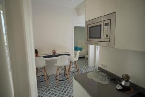a small kitchen with a table and chairs and a microwave at Domus Sole in Sorrento