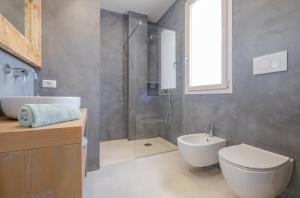 a bathroom with a shower and a toilet and a sink at Villa Agape Luxury Leuca by HDSalento in Leuca