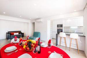 a living room with a red table with fruit on it at Apartment Brisbane by Algarve Vacation in Albufeira