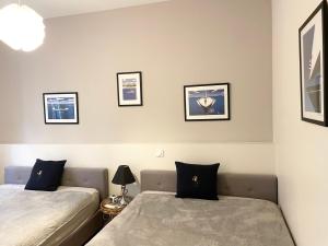 a bedroom with two beds and pictures on the wall at Cannes Old Port, Seafront & Seaview , fast wifi, best AC in Cannes