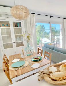 a living room with a table and a couch at StayMenorca Escapa a la naturaleza in Son Parc