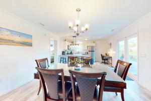 a kitchen and dining room with a table and chairs at The Birdhouse in St. George Island