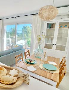 a dining room with a table and a couch at StayMenorca Redescubre la paz in Son Parc