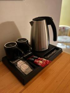 a coffeemaker sitting on a table with a coffee pot at Mazā Kāpa in Koknese