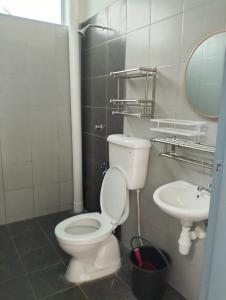 a bathroom with a toilet and a sink at Mahzan Homestay in Jitra