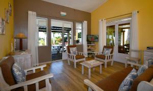 a living room with a couch and chairs at Fenetre sur Mer in Rodrigues Island