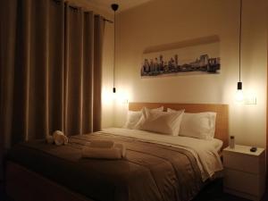 a bedroom with a bed with two towels on it at B&B Lamezia Nicogia in Lamezia Terme