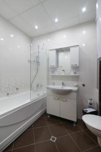 a bathroom with a tub and a sink and a shower at Infinity View Shkorpilovci in Shkorpilovtsi