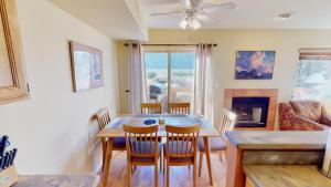 a dining room with a table and chairs and a fireplace at Kokopelli's Kiva #3230 in Moab