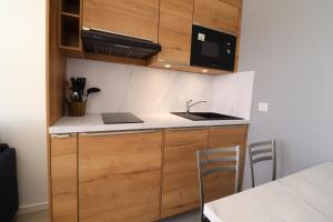 a kitchen with a sink and a counter top at Residence Pralin in Méribel