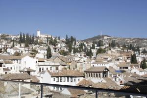 a view of a city with white houses at Amazing Loft! Rooftop Terrace! Alhambra Views! in Granada