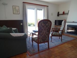 a living room with a couch and a table and chairs at Residenza Paradiso di Vacanze in Locarno