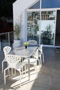 a table and chairs sitting on a patio at Amazing Loft! Rooftop Terrace! Alhambra Views! in Granada