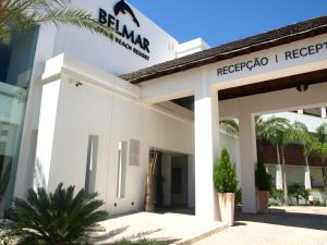 a white building with a sign that reads reggae i respect at Belmar Spa & Beach Resort in Lagos