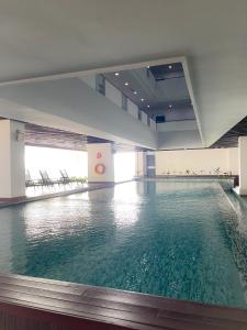a large pool of water in a large building at Atria SOFO Suites By Stay In in Petaling Jaya
