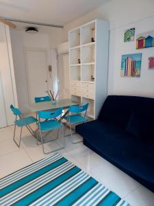 a bedroom with a bed and a table and chairs at SOLARE in Bibione