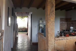 a hallway leading to a kitchen in a house at Casa Bari Bari in Barichara