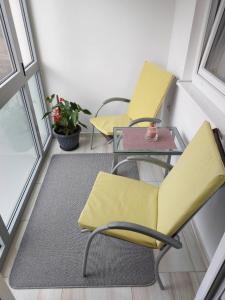 2 chaises jaunes et une table dans une pièce dans l'établissement Apartment YESA, à Travnik