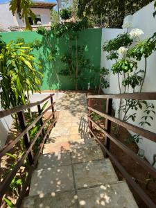 a walkway in a garden with a fence at Pipa Panorama Aparthotel in Pipa