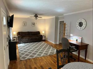a living room with a couch and a desk at Cozy 2 Bedroom Townhouse Near Lake and Restaurants in Guntersville