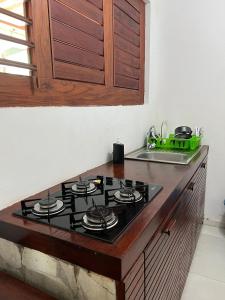 a stove top in a kitchen with a sink at Pipa Panorama Aparthotel in Pipa