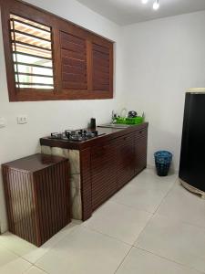 a kitchen with a stove and a counter top at Pipa Panorama Aparthotel in Pipa