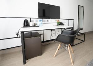 a black and white desk with a chair and a computer at Sarova Imperial Hotel in Kisumu