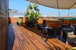 a deck with chairs and tables on a building at Hotel Soho in Barcelona +40 photos