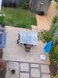 an overhead view of a table and chairs with an umbrella at Maria Farinha casa in Maria Farinha