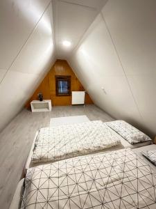 a bedroom with two beds in a attic at KOTA - Prime Location in Jahorina