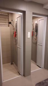 two stalls in a bathroom with two showers at SCC Hotel Chinatown in Kuala Lumpur