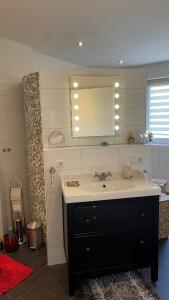a bathroom with a sink and a mirror at Ferienhaus Willmann in Böhme