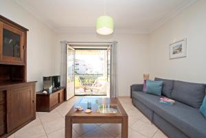 a living room with a couch and a coffee table at Apartment Montego Bay by Algarve Vacation in Albufeira