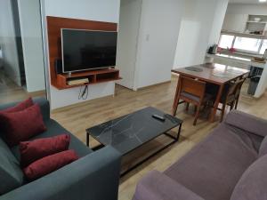 a living room with a couch and a table at Luxury Suite Salta in Salta