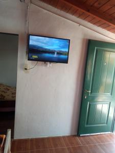 a flat screen tv on the wall of a room at Casa de alquiler 2 in Tanti
