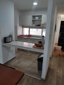a kitchen with a long counter in a room at Luxury Suite Salta in Salta