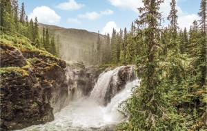 a waterfall in the middle of a forest at 2 Bedroom Pet Friendly Apartment In Hemsedal in Hemsedal