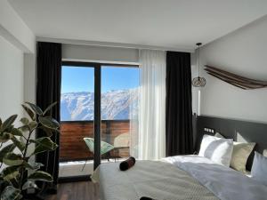 Schlafzimmer mit einem Bett und Bergblick in der Unterkunft Luxury hotel room with amazing views in Gudauri