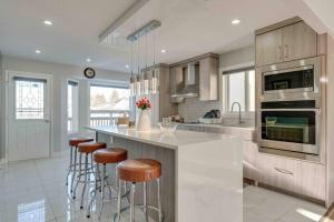 a kitchen with a island with bar stools at Rare Find fully renovated 6 bedroom 3 bath and both levels in Calgary