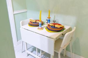 a table with plates of food and candles on it at 2 Bedroom Suite in Miami in North Miami Beach