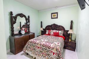 a bedroom with a bed and a dresser and a mirror at 2 Bedroom Suite in Miami in North Miami Beach