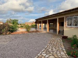 a house with a gravel driveway next to a building at Villa Idaka in Rufisque