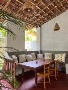 a wooden table and chairs in a room with a couch at Jungle Villa in Ahangama