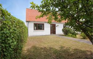 a white house with a red roof and a yard at Nice Home In Sams With 2 Bedrooms And Wifi in Toftebjerg
