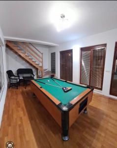 a living room with a pool table in a room at Kuća za odmor Niki in Pale