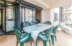 a table and chairs on a patio with a balcony at Stunning Apartment In Oropesa Del Mar in Oropesa del Mar